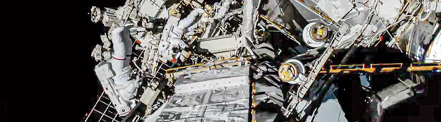 Astronauts on a spacewalk outside the International Space Station
