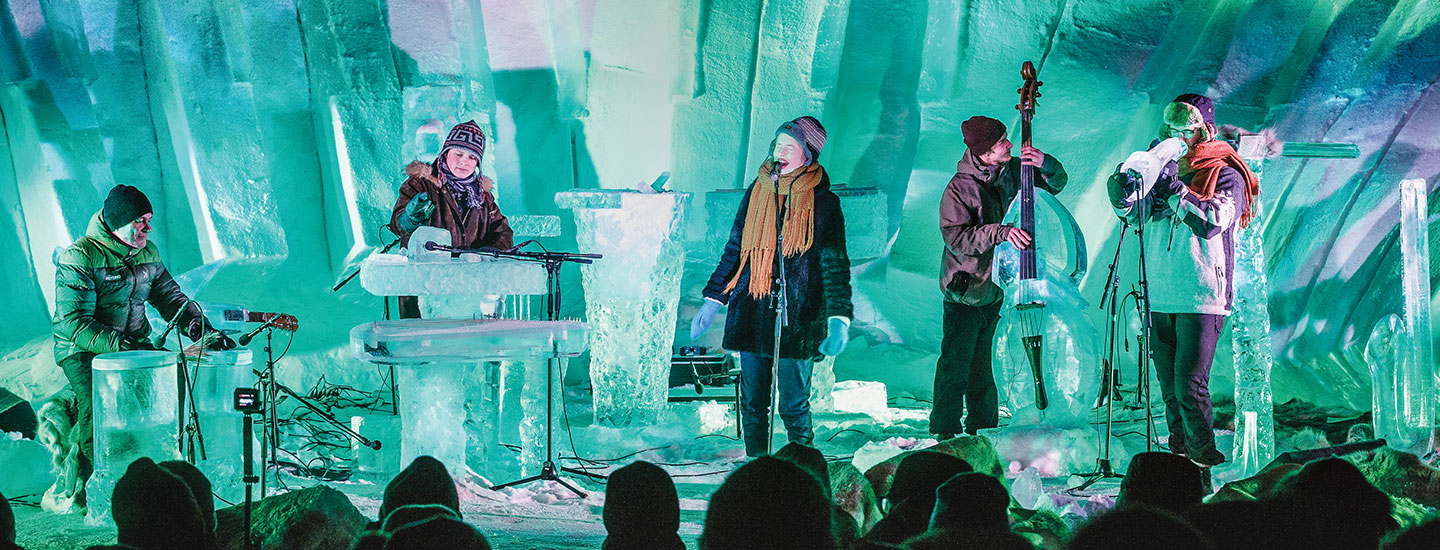 Musicians playing on instruments made of ice