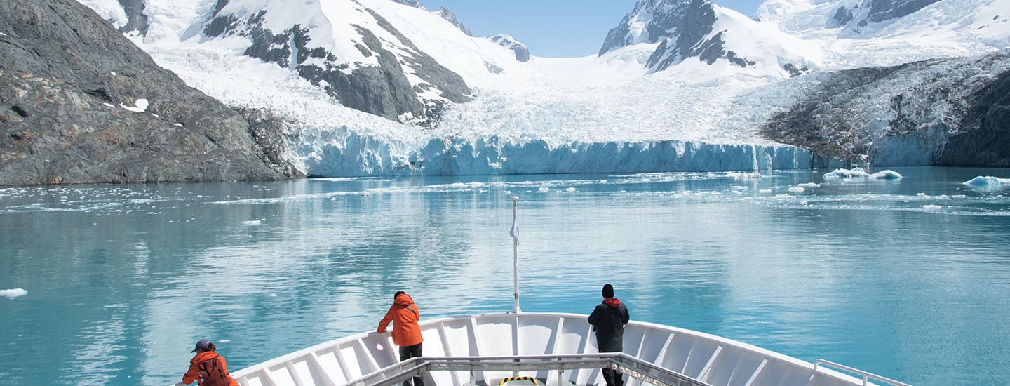 Photo of people on a ship in the waters of Antarctica