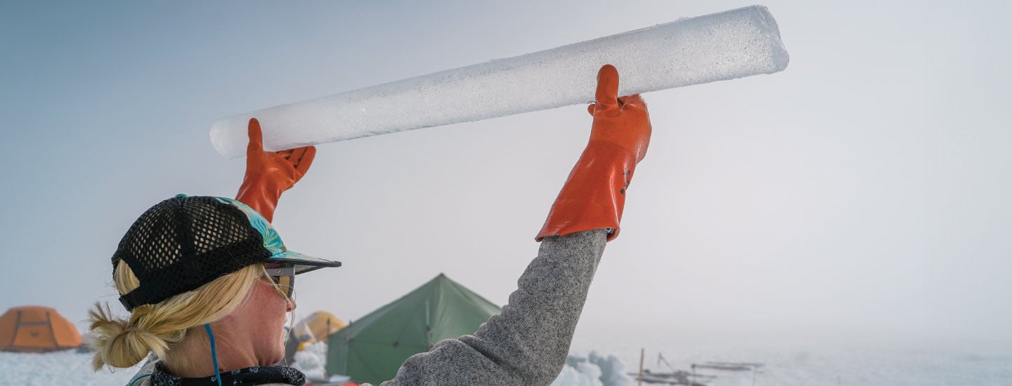 Image of scientist holding long tube