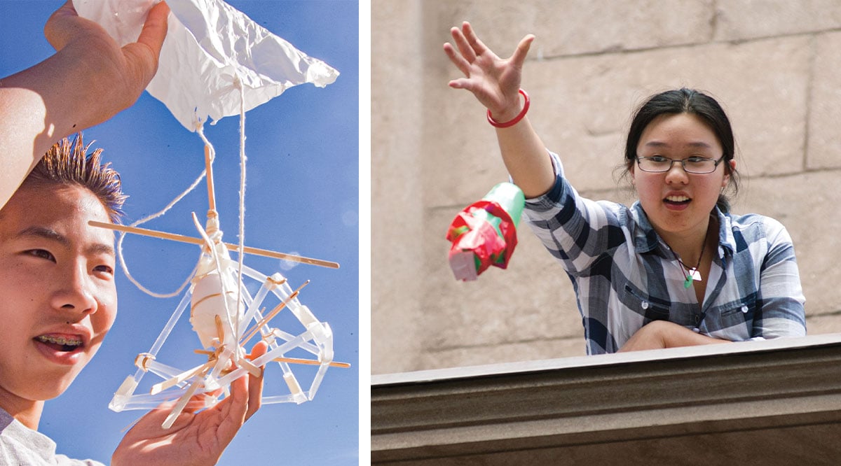 A boy holds a parachute made from sticks and plastic; a girl tosses a parachute from a ledge