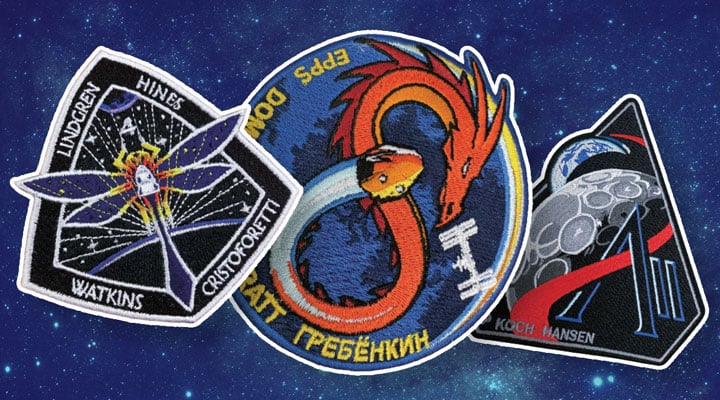 Three spaceflight crew patches lie on a starry background, one showing a dragon circling Earth
